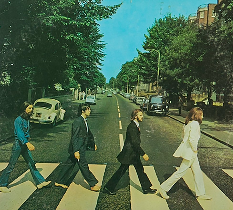 Famous vinyl album cover of The Beatles' "Abbey Road" featuring the band crossing a zebra crossing